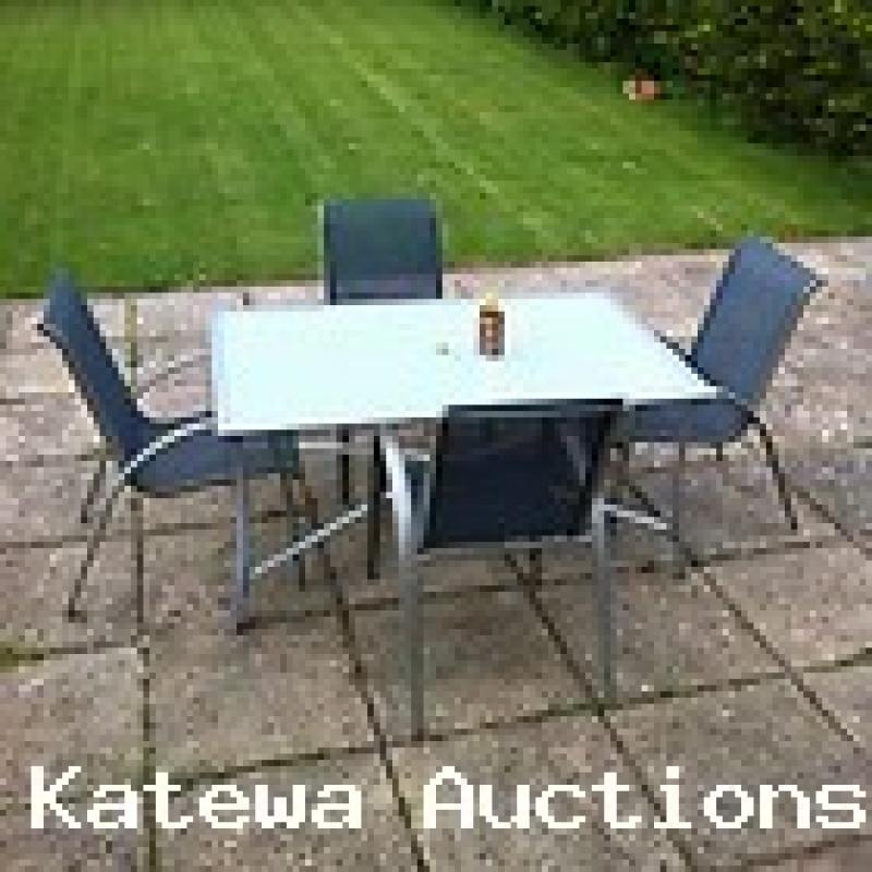 GLASS TABLE 5 X 3 WITH 4 METAL FRAMED WEATHERPROOF STACKIABLE CHAIRS